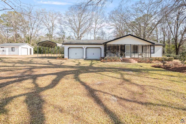 ranch-style home featuring a garage, a front yard, a carport, and a porch