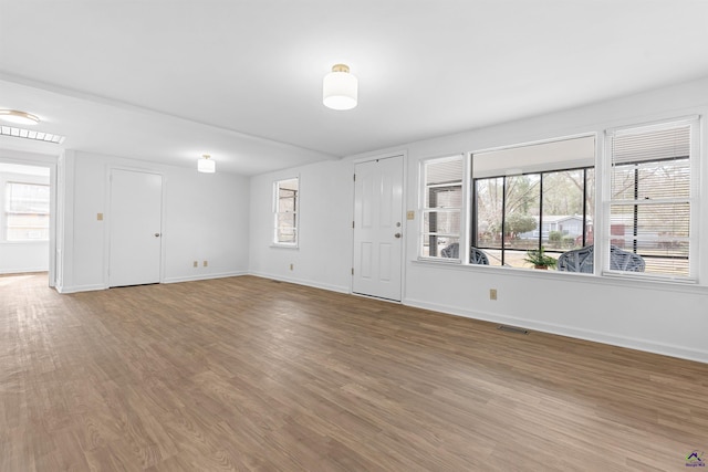 interior space with hardwood / wood-style flooring and plenty of natural light