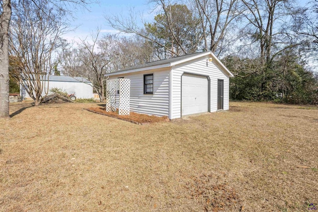 garage featuring a lawn