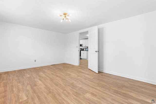 unfurnished room with light wood-type flooring