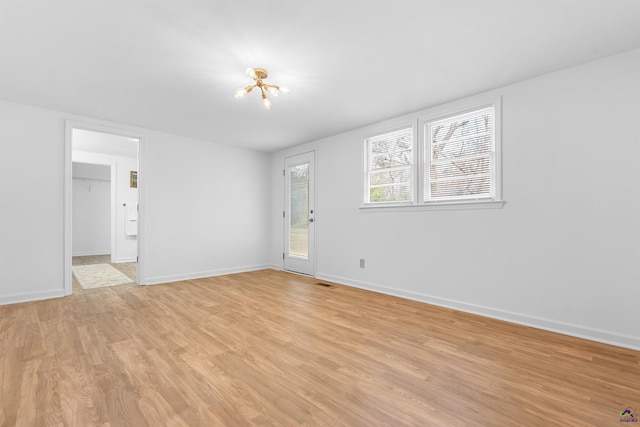 empty room with light hardwood / wood-style flooring