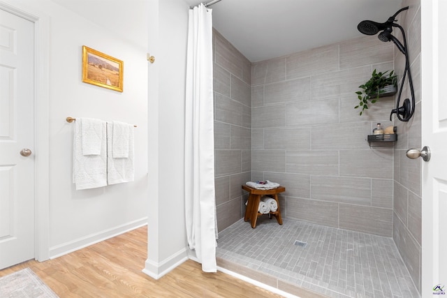 bathroom featuring wood-type flooring and a shower with shower curtain