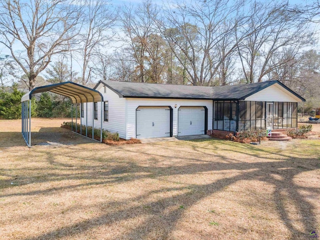 exterior space with a carport, a garage, a sunroom, and a lawn