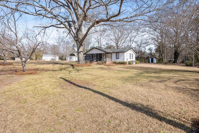 exterior space featuring a storage shed and a front yard