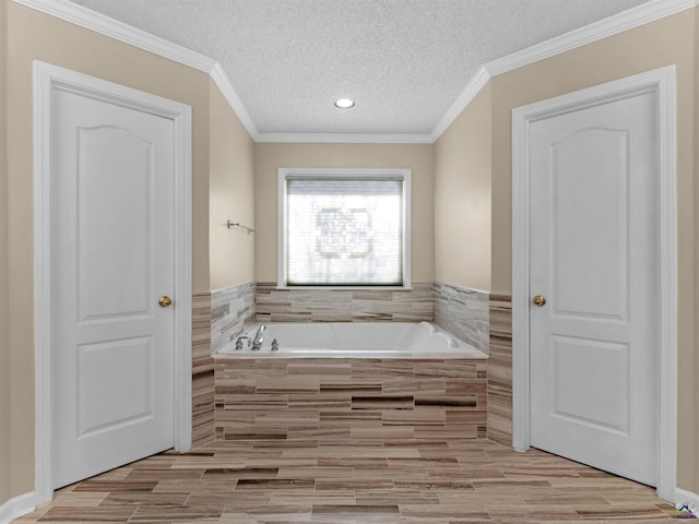 bathroom featuring crown molding, a relaxing tiled tub, and a textured ceiling