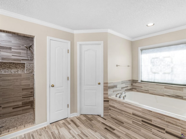 bathroom featuring crown molding, plus walk in shower, and a textured ceiling