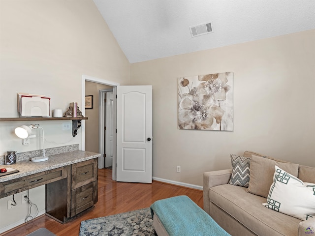 office with lofted ceiling and hardwood / wood-style floors