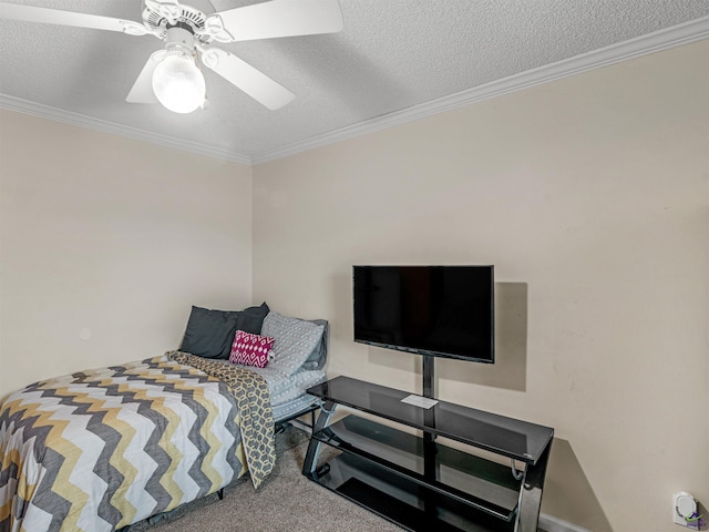 carpeted bedroom featuring ornamental molding, ceiling fan, and a textured ceiling