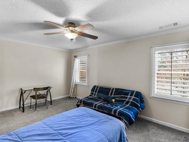 carpeted bedroom featuring ceiling fan, ornamental molding, and a textured ceiling