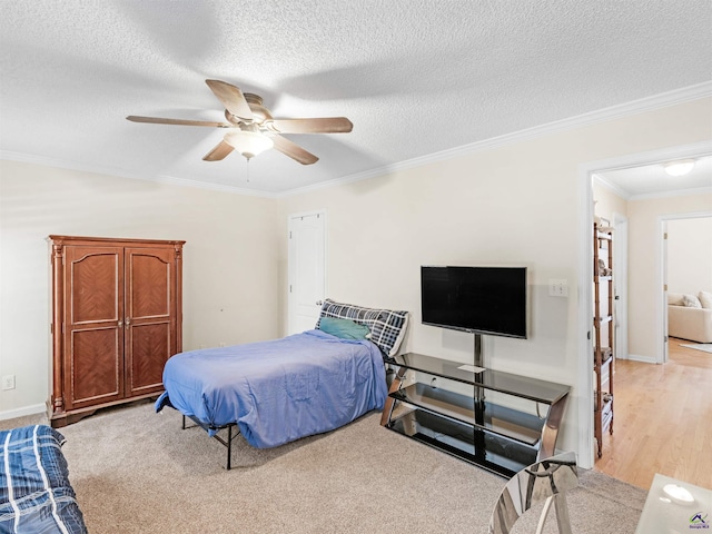 bedroom with ceiling fan, ornamental molding, and a textured ceiling