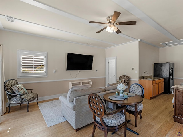 living room with ceiling fan, sink, and light hardwood / wood-style flooring