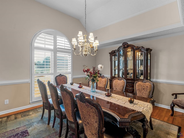 dining area with dark hardwood / wood-style flooring, crown molding, lofted ceiling, and a chandelier