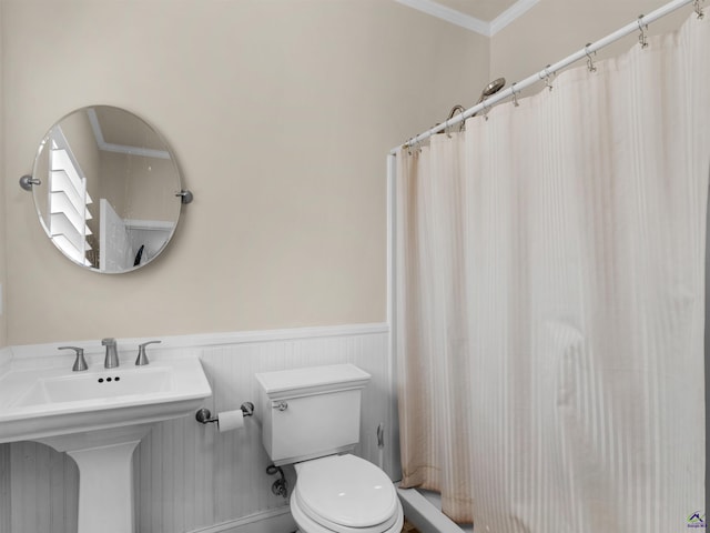 bathroom featuring crown molding, sink, walk in shower, and toilet