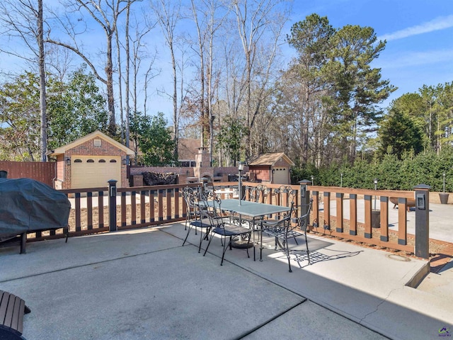 view of patio with an outbuilding, a garage, and grilling area