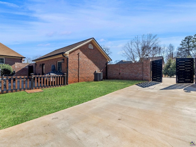 view of home's exterior with a lawn and central air condition unit