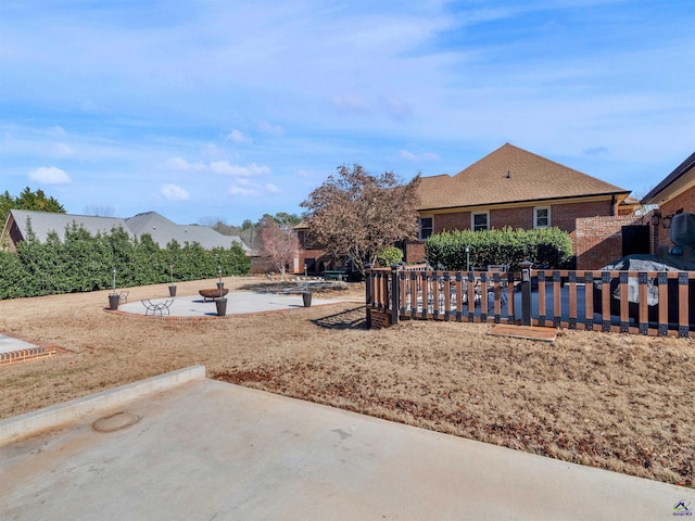 view of yard with an outdoor fire pit and a patio area