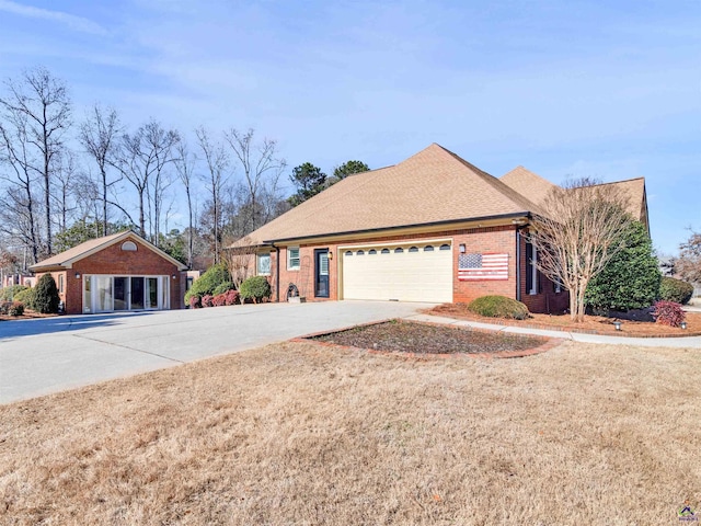 view of side of home featuring a garage and a yard