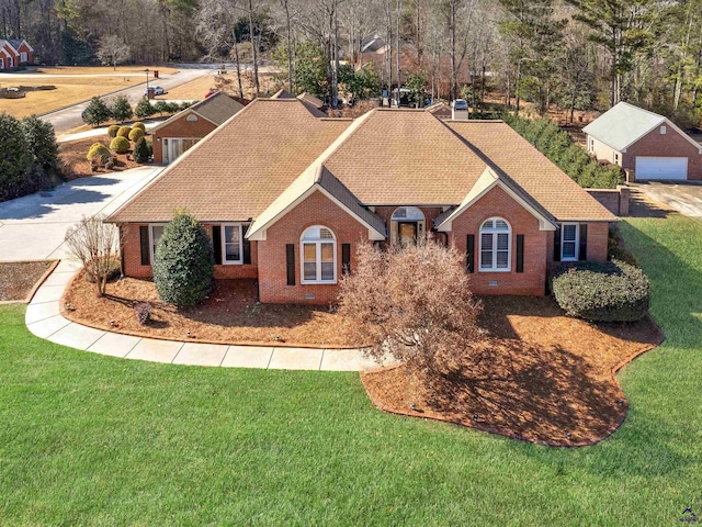 view of front of home with a garage and a front lawn