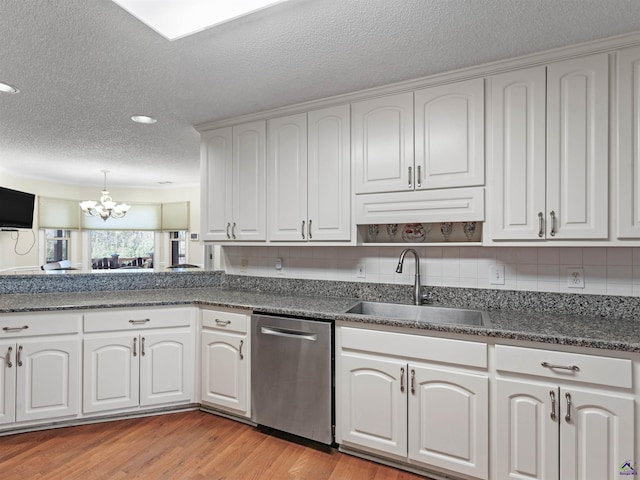 kitchen featuring sink, white cabinetry, dishwasher, light hardwood / wood-style floors, and decorative backsplash