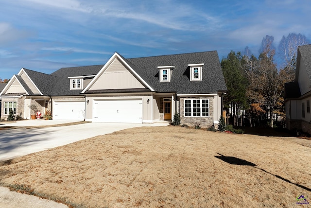 view of front of property featuring an attached garage, driveway, and roof with shingles