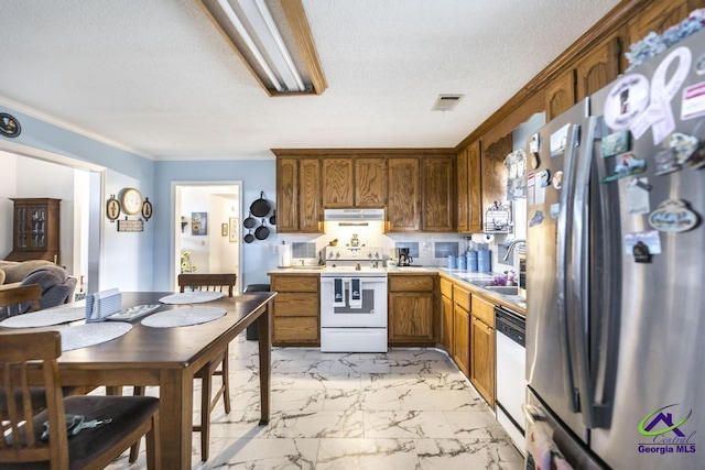 kitchen featuring crown molding, sink, and white appliances