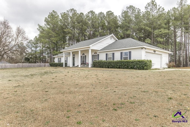 view of front of house with a garage, covered porch, and a front lawn