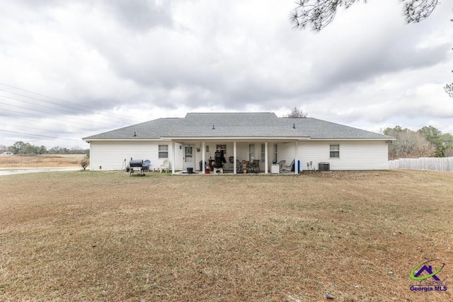 back of house with a patio and a yard