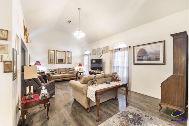 living room with vaulted ceiling, dark wood-type flooring, and a notable chandelier