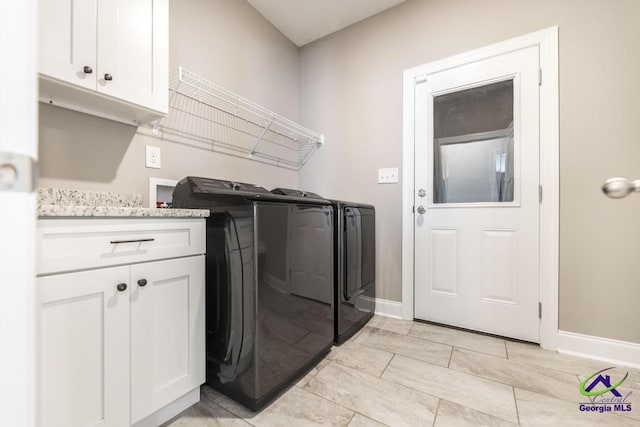 washroom with cabinets and independent washer and dryer