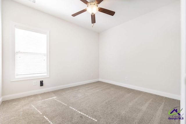 unfurnished room with ceiling fan and carpet floors