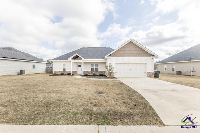 craftsman-style home with a garage, a front yard, and central air condition unit