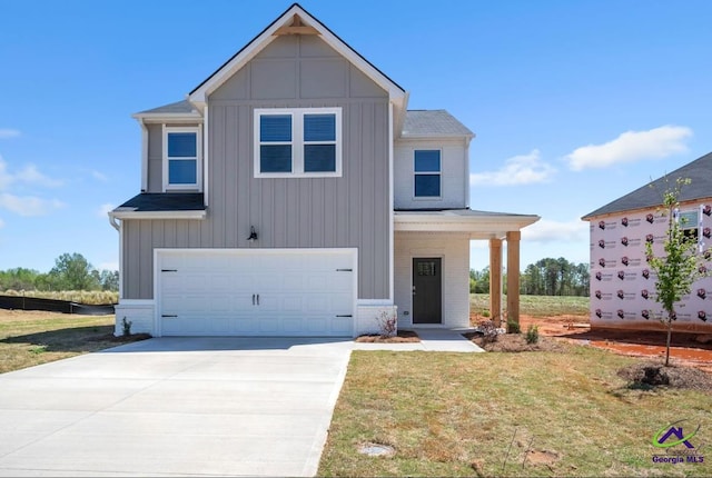 view of front of home featuring a garage and a front yard