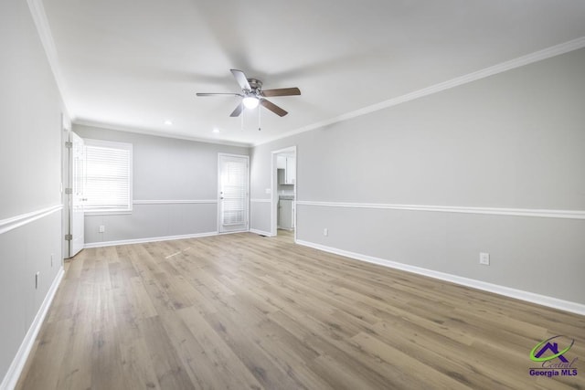 spare room featuring light hardwood / wood-style flooring, ornamental molding, and ceiling fan