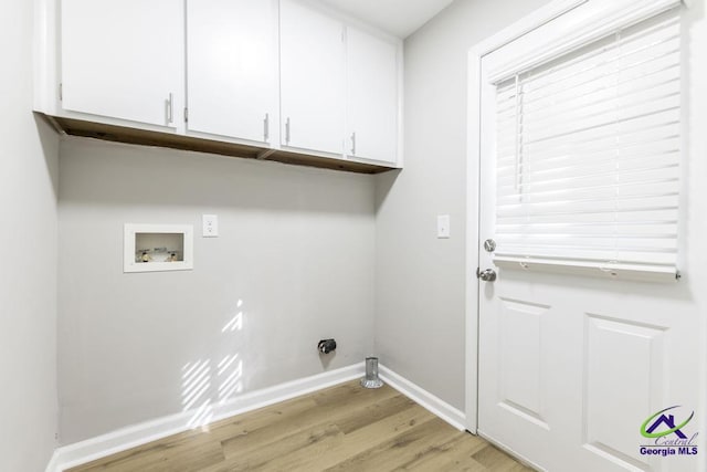 laundry room with cabinets, washer hookup, and light hardwood / wood-style floors