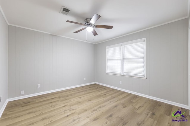 empty room featuring crown molding, ceiling fan, and light wood-type flooring