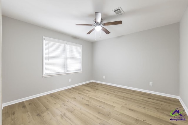 spare room with ceiling fan and light wood-type flooring