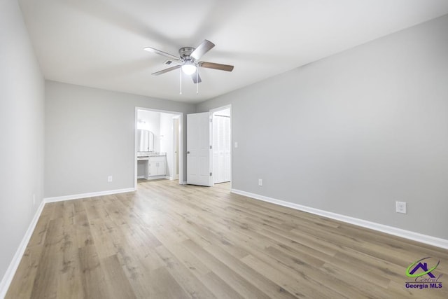 unfurnished bedroom with ensuite bath, light hardwood / wood-style floors, and ceiling fan