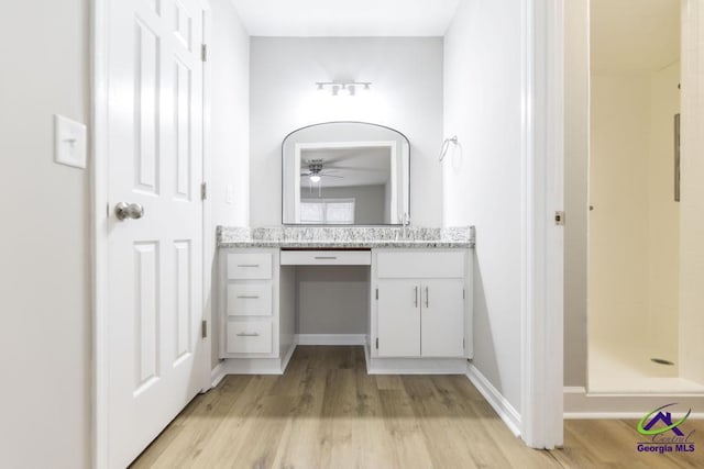 bathroom featuring vanity, hardwood / wood-style floors, and a shower