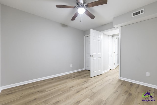 unfurnished bedroom with ceiling fan and light wood-type flooring