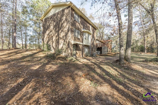 rear view of property featuring a wooden deck