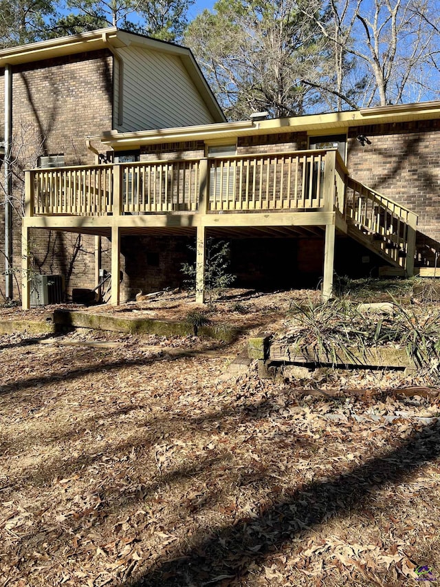 view of property exterior featuring a wooden deck and central air condition unit