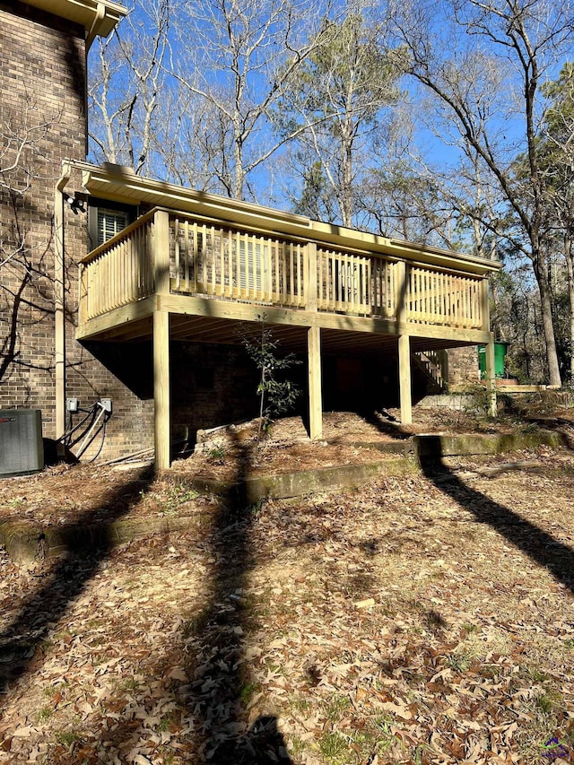 view of property exterior featuring central AC unit and a deck