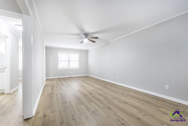 empty room with light hardwood / wood-style flooring, ornamental molding, and ceiling fan