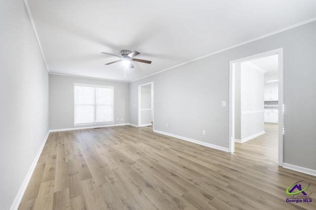 spare room featuring crown molding, ceiling fan, and light hardwood / wood-style flooring