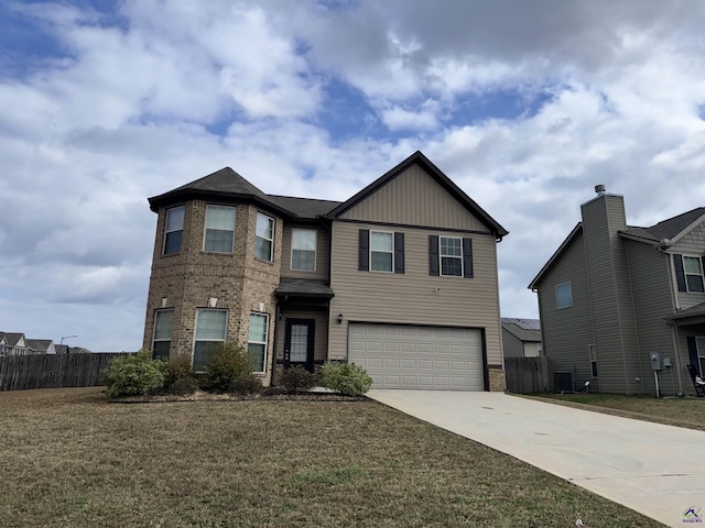 view of front of home with cooling unit, a garage, and a front yard