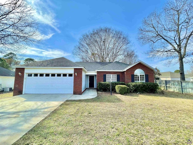 ranch-style home with a garage and a front yard