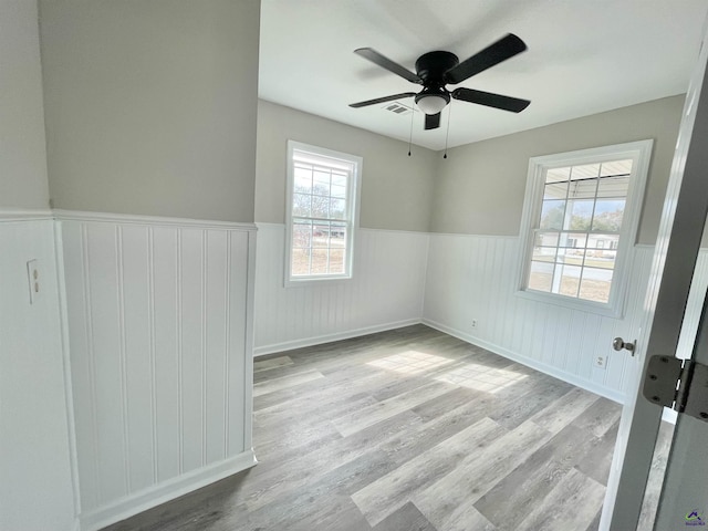 empty room featuring ceiling fan and light hardwood / wood-style flooring