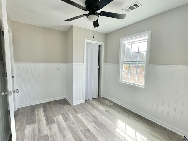 unfurnished bedroom featuring a closet, ceiling fan, and light hardwood / wood-style flooring