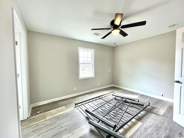 unfurnished room featuring hardwood / wood-style flooring and ceiling fan