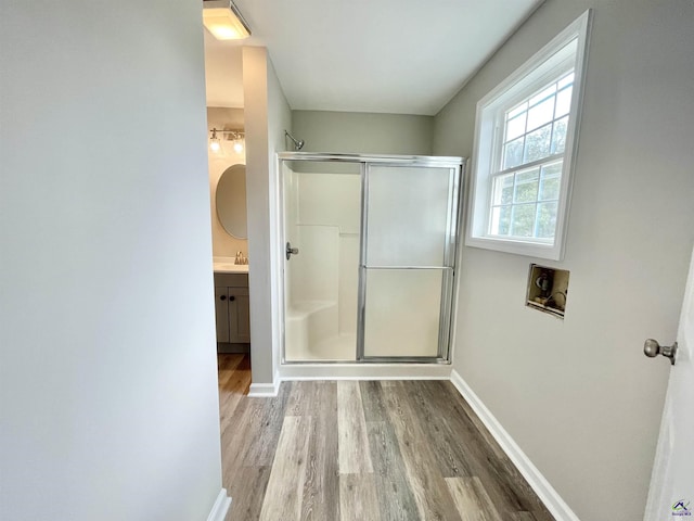 bathroom with vanity, hardwood / wood-style floors, and walk in shower